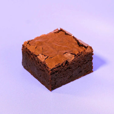 Classic Brownie from Crumbs & Doilies with a fudgy bottom and shiny crackly top, baked fresh for perfect chocolate flavor.